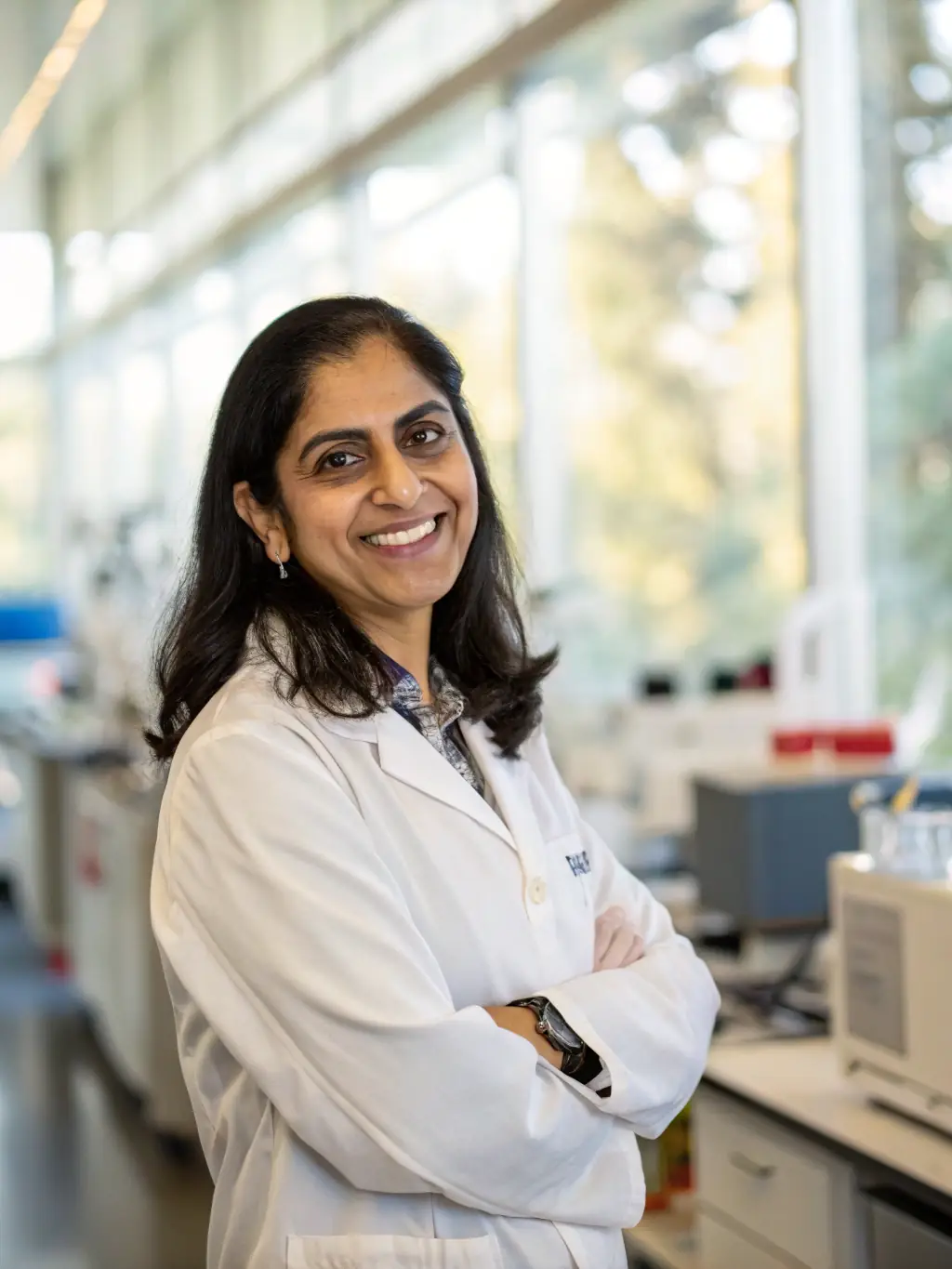 A professional headshot of Dr. Anya Sharma, a leading expert in change management, smiling confidently. She is a keynote speaker at the ConfusionZone conference.